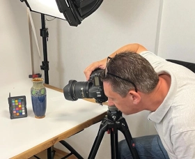 A member of our team photographing a vase.