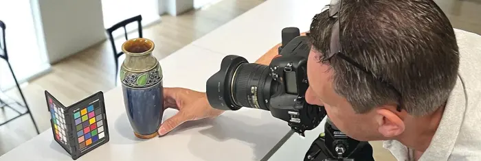 A member of our team photographing a vase.